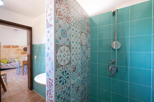 a bathroom with a shower with blue tiles at Casa Varvodda in San Vito dei Normanni