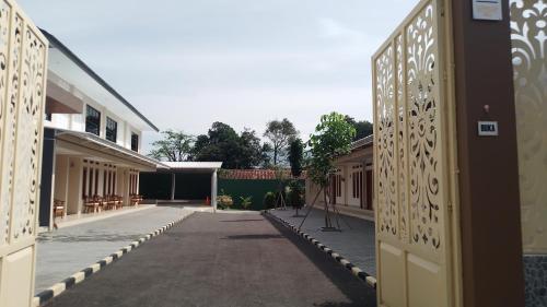 an empty courtyard of a building with a gate at Family Guest House in Sumedang Utara