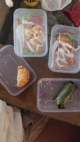 three plastic containers with food in them on a table at Family Guest House in Sumedang Utara