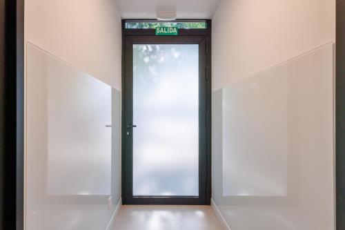 a door in a building with a sign on it at WE MADRID STUDIOS centro in Madrid