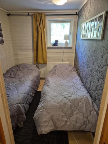 a bedroom with two beds and a window at Idre in Idre