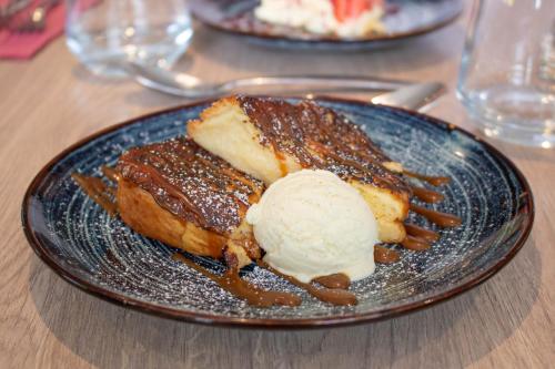 a plate with a dessert with ice cream on it at Brit Hotel Angers Parc Expo - L'Acropole in Saint-Sylvain-dʼAnjou