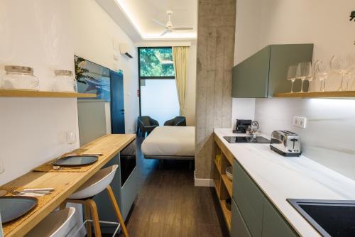 a kitchen with a sink and a bed in a room at WE MADRID STUDIOS centro in Madrid