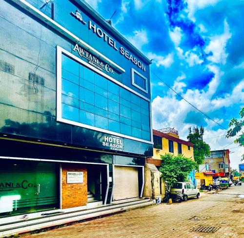 a building on the side of a street at Hotel Season in Ahmedabad