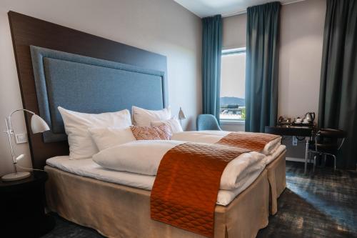a hotel room with a large bed and a window at Clarion Hotel Bergen Airport in Bergen