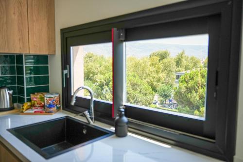 a kitchen sink with a window in a kitchen at SOHO Residence in Selcuk