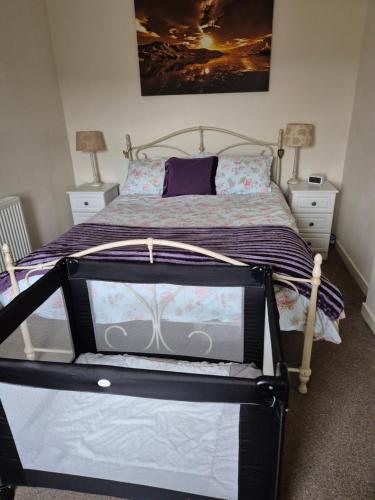 a bedroom with a bed and two night stands at RAWSON COTTAGE LOVELY 2 BEDROOM SEMI RURAL in Stranraer
