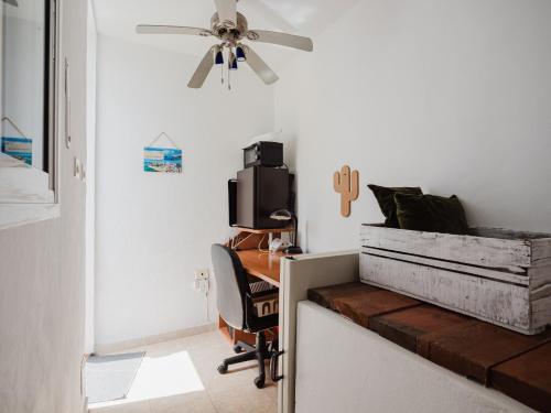 Habitación con escritorio y ventilador de techo. en Ruta del Perenquén by Villas Rivero, en Agüimes