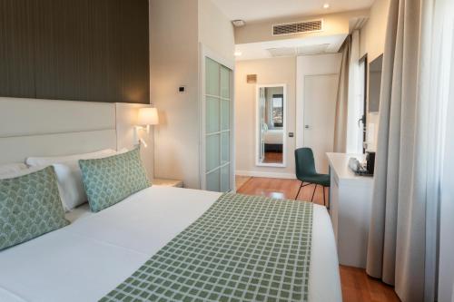 a hotel room with a bed and a bathroom at Catalonia Plaza Mayor Salamanca in Salamanca
