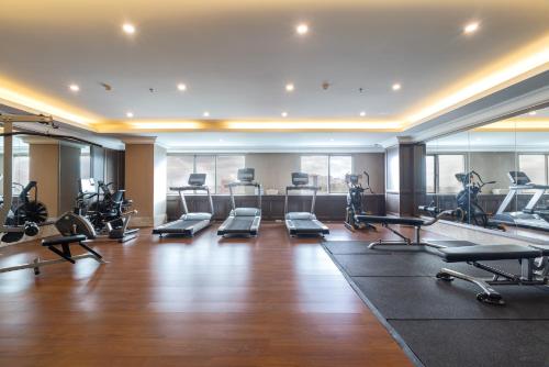 a gym with treadmills and exercise equipment in a building at ARTOTEL Suites Aquila - Bandung in Bandung