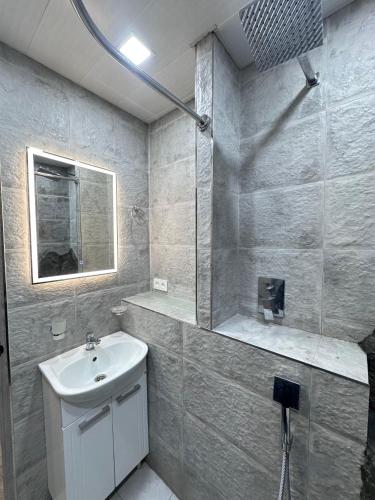 a bathroom with a sink and a mirror at Tnak-Erevan in Yerevan