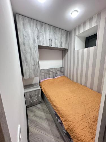 a small bedroom with a bed in a room at Tnak-Erevan in Yerevan