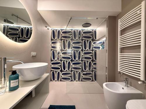 a bathroom with a sink and a shower curtain at Villa Emma Exclusive in Vico Equense