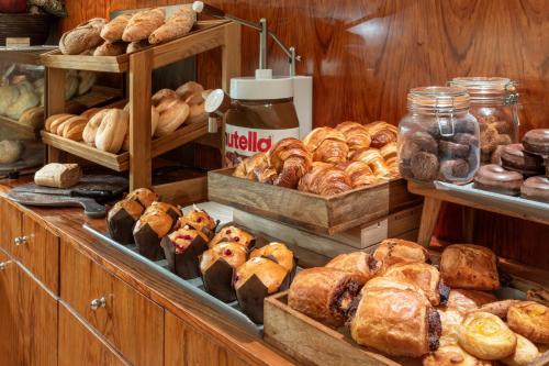a bakery with lots of different types of bread at Catalonia Plaza Mayor Salamanca in Salamanca