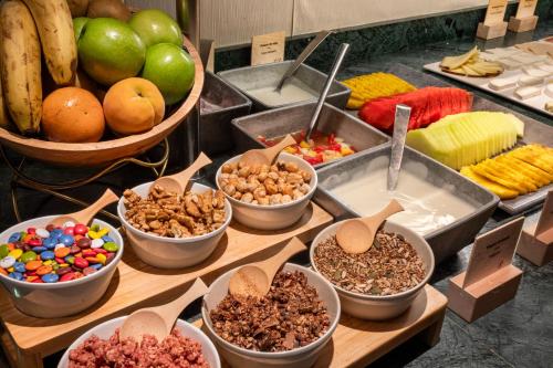 a buffet of food with bowls of nuts and fruit at Catalonia Plaza Mayor Salamanca in Salamanca