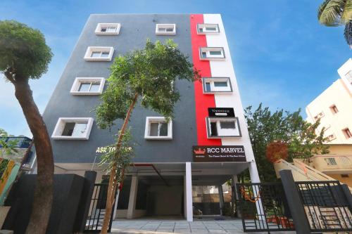 a building with a red stripe on the side of it at Super townhouse Dilshuk Nagar in Hyderabad