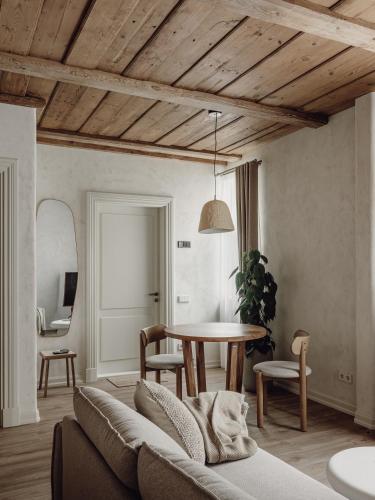a living room with a couch and a table at Mācītāja māja in Cēsis