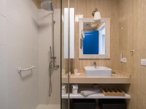 a bathroom with a sink and a shower with a mirror at Blue Horizon Mogan in Puerto de Mogán