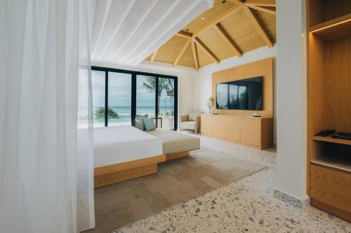 a bedroom with a bed and a view of the ocean at Melia Zanzibar in Kiwengwa