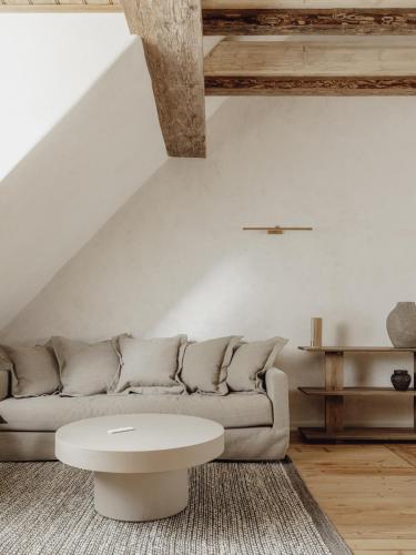 a living room with a couch and a table at Mācītāja māja in Cēsis
