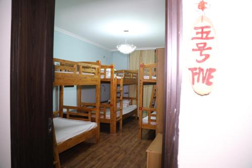 a room with a group of bunk beds at Xi'an The Facebook Youth Hostel in Xi'an