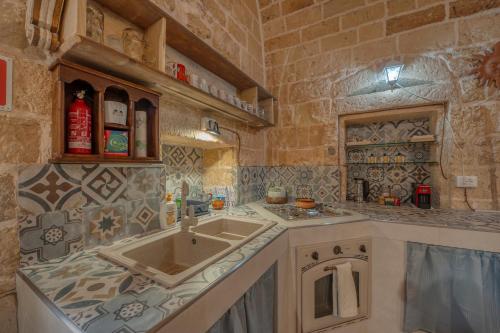 a kitchen with a sink and a counter top at San Leonardo Apartments in Lecce