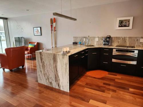 a kitchen with a marble counter top in a room at Saugatuck Waterfront Getaway Shop, Eat, Bike, Pool in Saugatuck