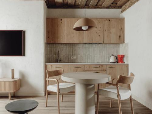 a kitchen with a table and chairs in a room at Mācītāja māja in Cēsis