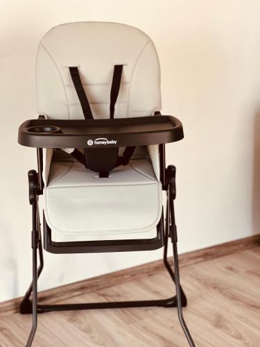 a black and white chair against a wall at Lumen Apartment in Néa Péramos