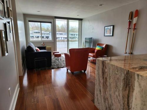 a living room with two chairs and a counter top at Saugatuck Waterfront Getaway Shop, Eat, Bike, Pool in Saugatuck