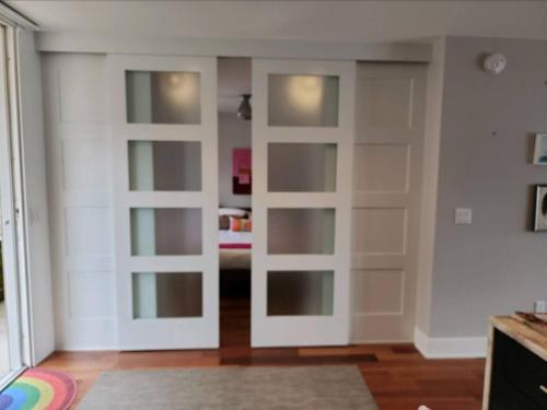 a room with sliding doors in a living room at Saugatuck Waterfront Getaway Shop, Eat, Bike, Pool in Saugatuck
