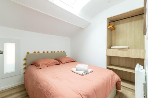 une chambre avec un lit avec un couvre-lit rose dans l'établissement Cocon Dacquois, à Dax