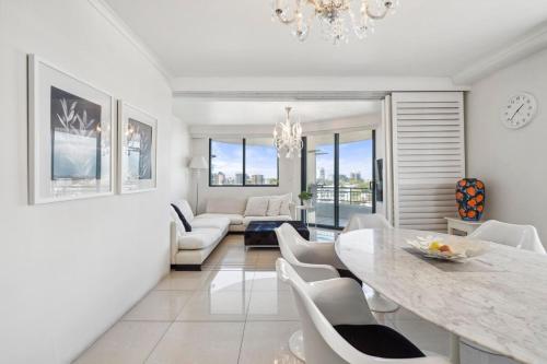 a dining room with a table and chairs and a living room at 92AH Abnb-Style Central Sydney 1BR, Free Parking, Prime Location in Sydney
