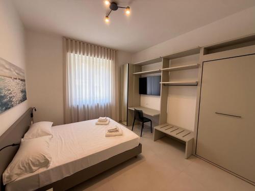 a small bedroom with a bed and a desk at MONTELLA B&b in Gaeta