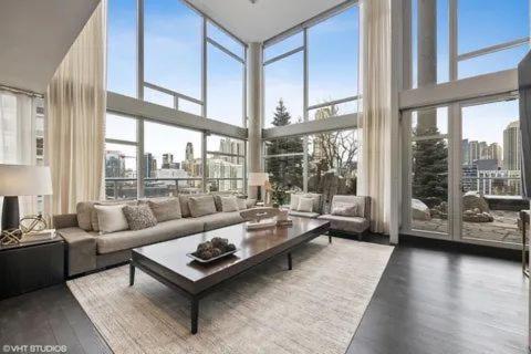 a living room with a couch and large windows at Erik's homes in Fort Bragg