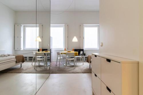 a kitchen and living room with a couch and a table at Charming and Well-Located Studio in Chiado in Lisbon
