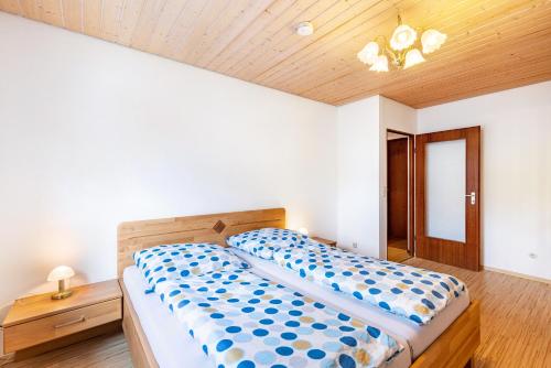 a bedroom with a bed and a wooden ceiling at Haus Wiesengrund - Hundefreundlich in Gammertingen