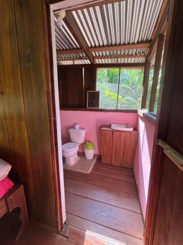 a small bathroom with a toilet and a sink at Sabalo Lodge Tours and Cabins in Sierpe