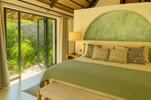 a bedroom with a large bed and a large window at O'Leleshwa Retreat in Naivasha