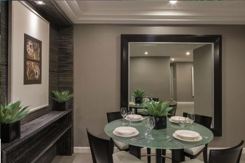 a dining room with a table and a mirror at Astoria Plaza in Manila