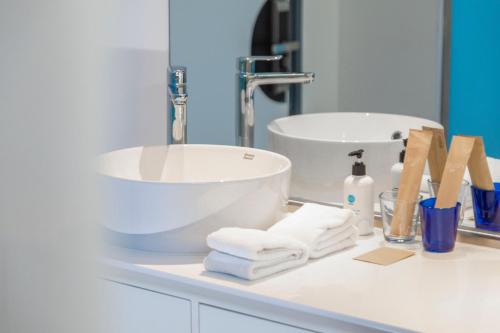 a bathroom counter with a sink and towels at Tru by Hilton Bac Giang City Centre in Bắc Giang