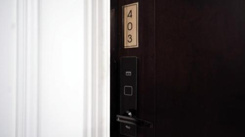 an elevator door with the number on it at Poshtel 56 in Bangkok