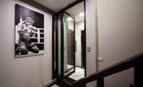 a bathroom with a picture of a boxer on the wall at Poshtel 56 in Bangkok