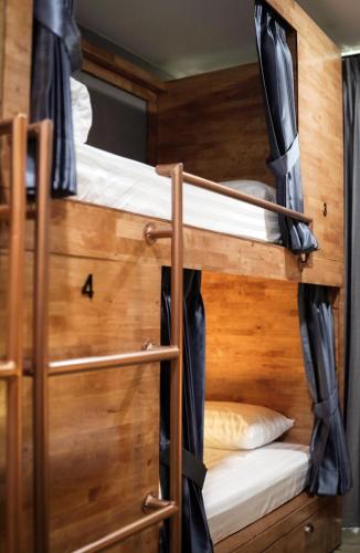 a couple of bunk beds in a room at Poshtel 56 in Bangkok