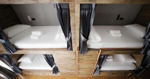 a overhead view of three beds in a room at Poshtel 56 in Bangkok