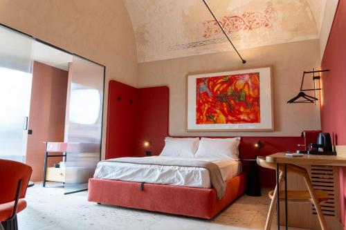 a bedroom with a large bed with a red headboard at Casa Tre Archi - Camere Luxury in Altamura
