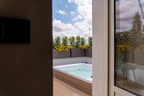 a hot tub on the balcony of a house at Casa Tre Archi - Camere Luxury in Altamura