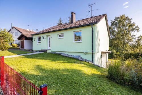 a house with a green and white house at Haus Wiesengrund - Hundefreundlich in Gammertingen