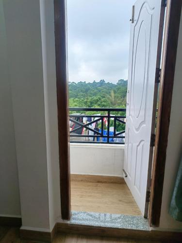 a door leading to a balcony with a view at Mawdong Homestay in Shillong