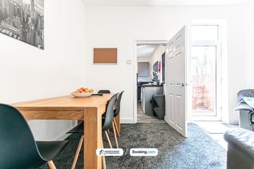 a dining room with a wooden table and chairs at Severn Street House Serviced Accommodation in Leigh